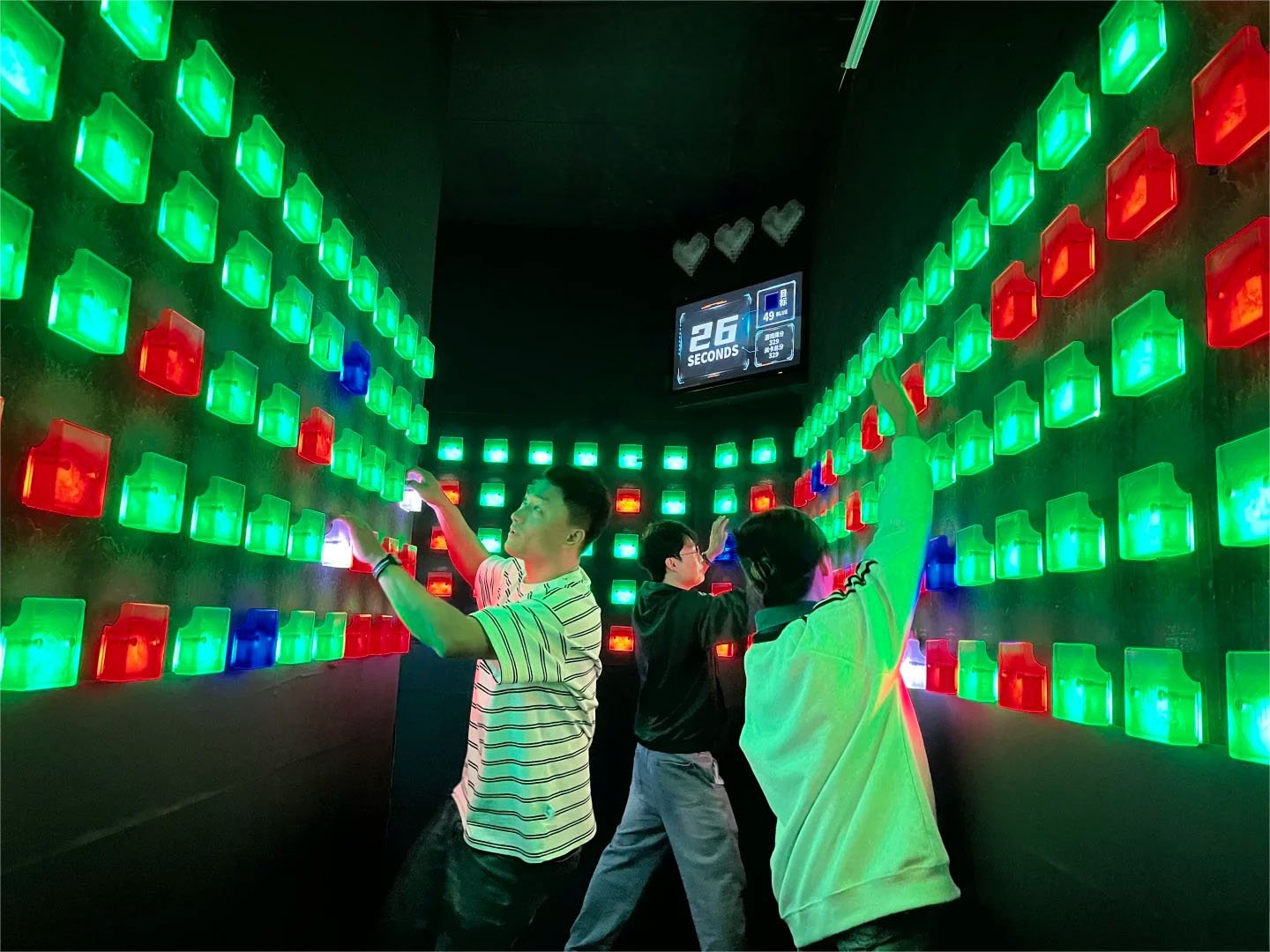 3 players are playing the challenge mode of climb, holding the green cube and touching the blue cube at the same time