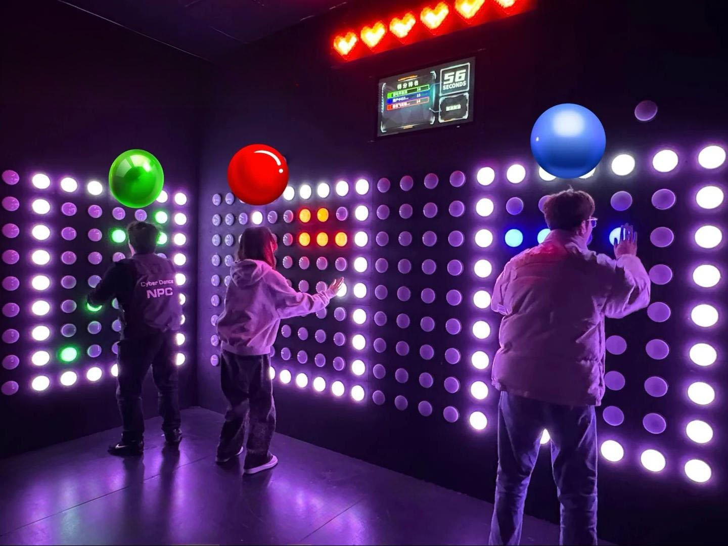 In the Spot & Push game room, three players compete to press buttons of their respective colors.