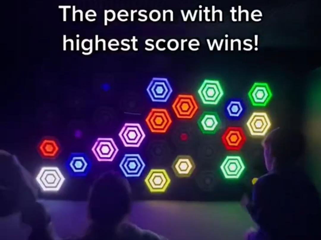 Multiple players are competing with each other to see who can hit the most color blocks.