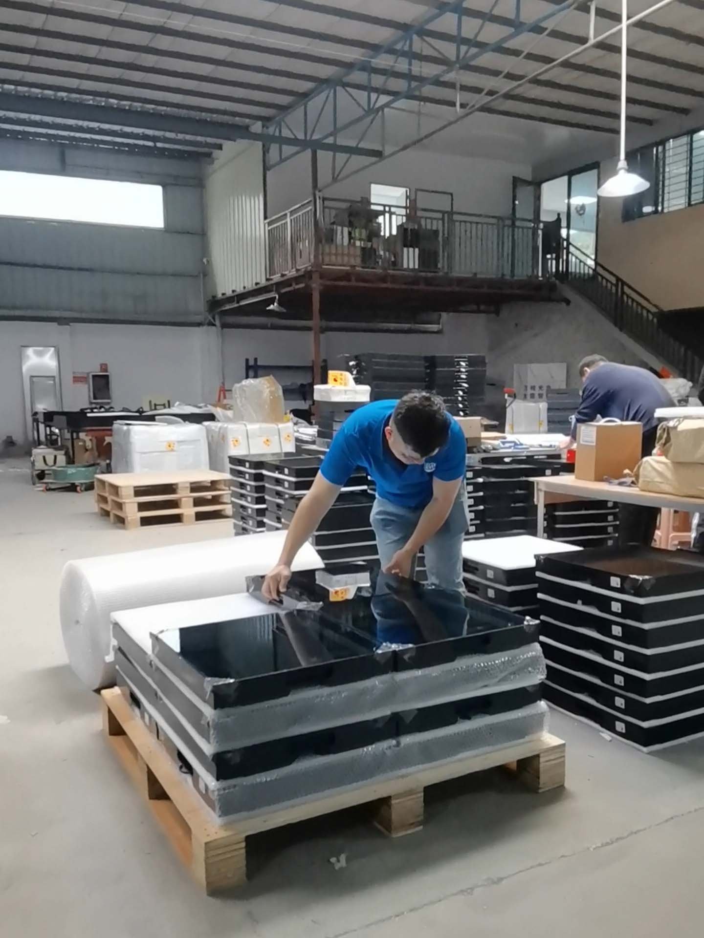 Workers are packing the LED dance floor for shipment