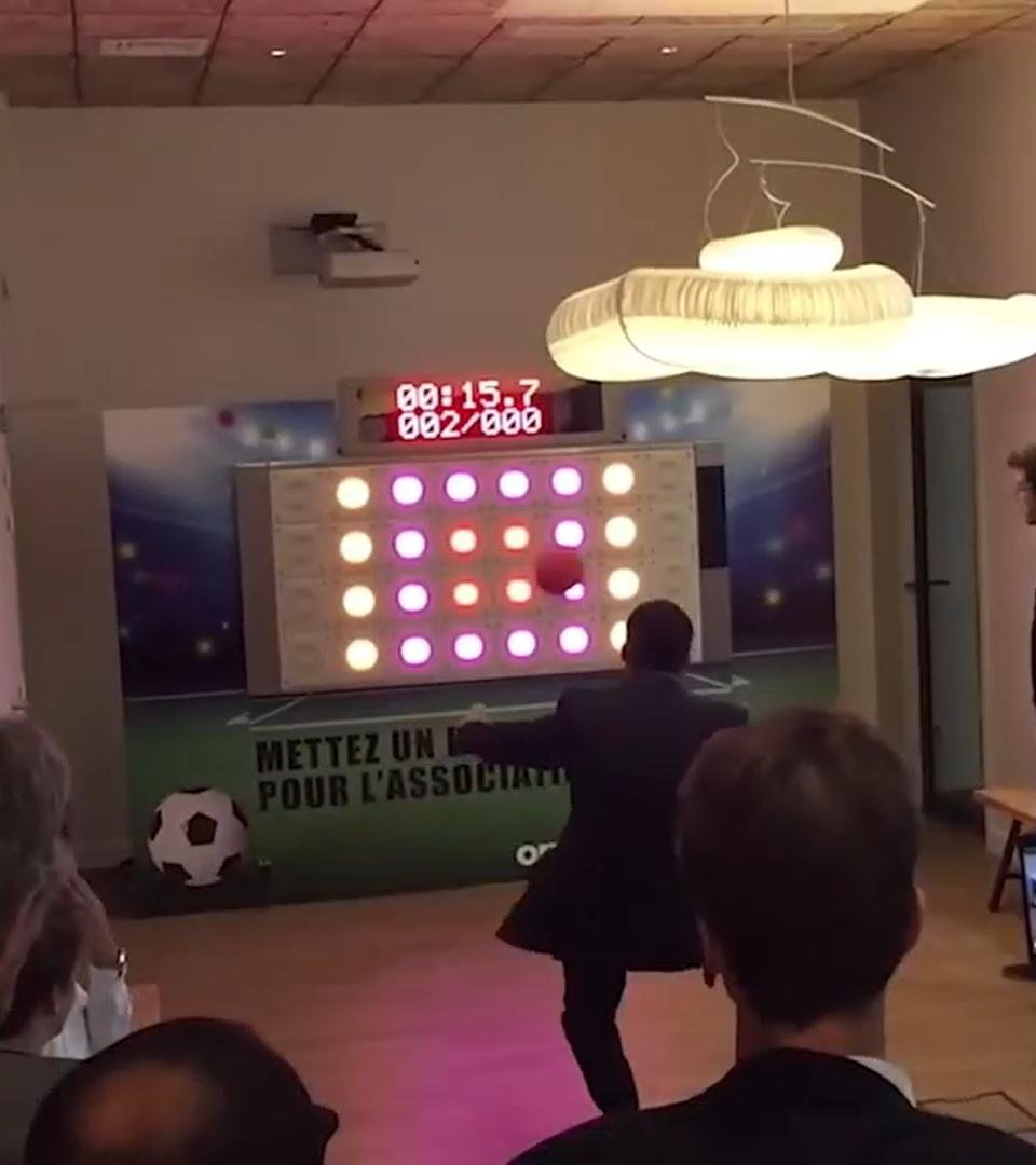The player kicks the football and hits the target block in Sensing Sports Wall