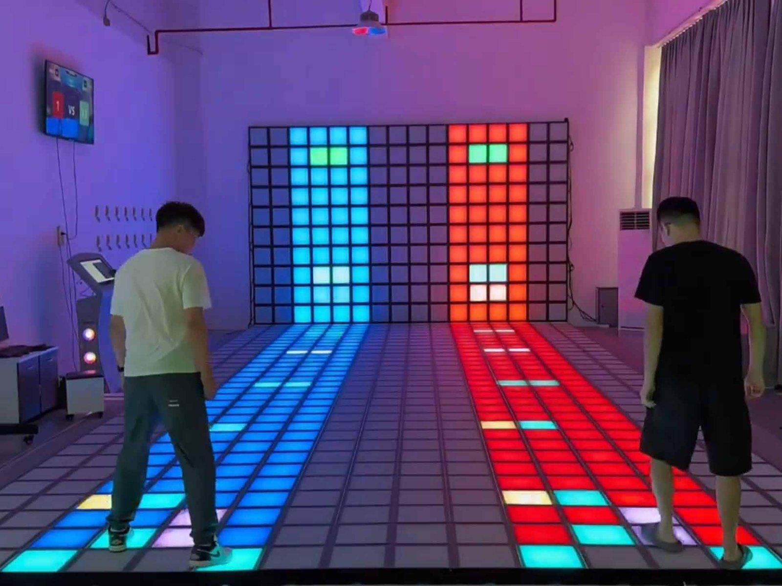 Two players are playing the just dance mode. When the block is about to arrive, they step on it immediately.
