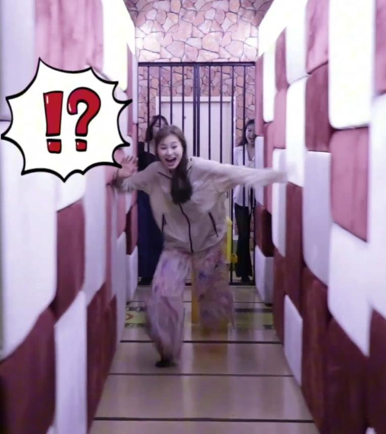 A player running to escape between moving soft-padded walls in a Compression Wall challenge room.