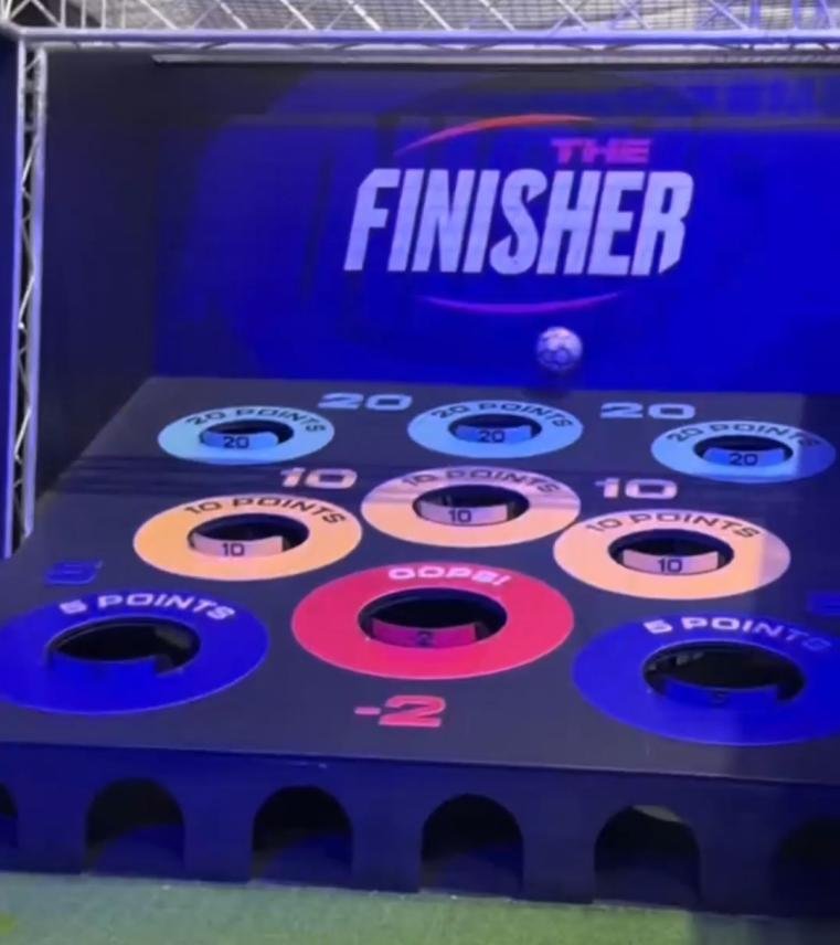 A football precision target ramp featuring various scoring holes in a Football Hole Scoring challenge room.